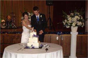 The cake topper has the bride standing on a suitcase.
